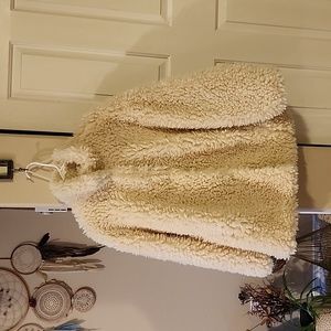 Faux fur coat. Silk lined. Snap closure down front of coat. High neck. Pockets.